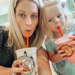 Happy Mother and Daughter Drinking their fresh Monkee Fruit Smoothies.